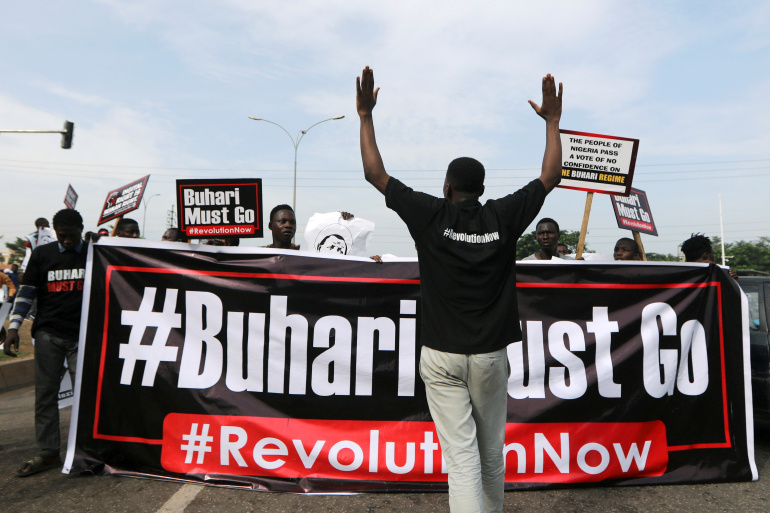 Protesters carry placards and banners during a June 12 Democracy Day rally in Abuja, Nigeria June 12, 2021. REUTERS/Afolabi Sotunde     TPX IMAGES OF THE DAY