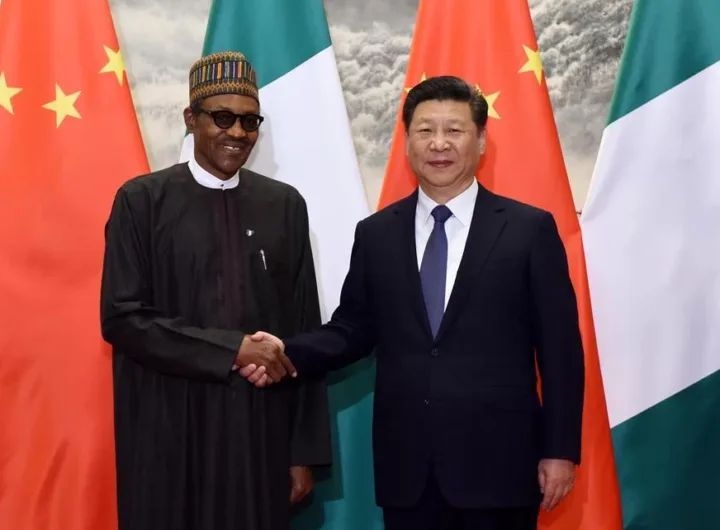 Presidents Muhammadu Buhari of Nigeria and Xi Jinping of China exchange pleasantries during an event/Getty