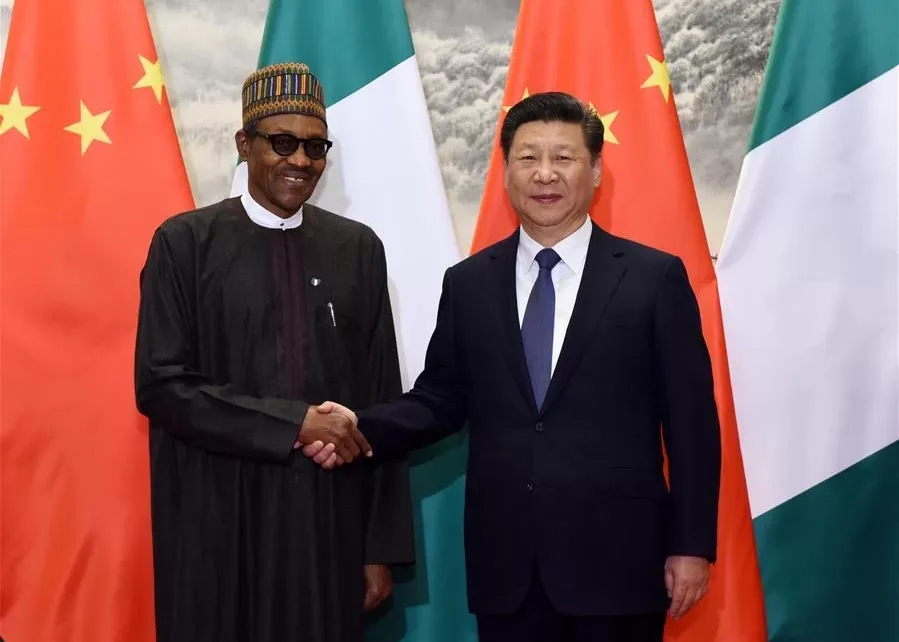Presidents Muhammadu Buhari of Nigeria and Xi Jinping of China exchange pleasantries during an event/Getty