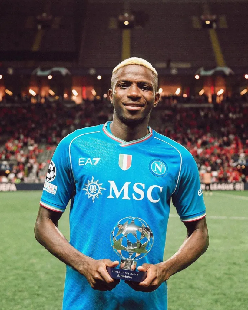 Osimhen poses with a Man-of-the-Match award for Napoli in the UEFA Champions League