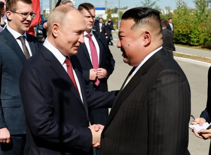 Putin and Kim exchange pleasantries/Reuters