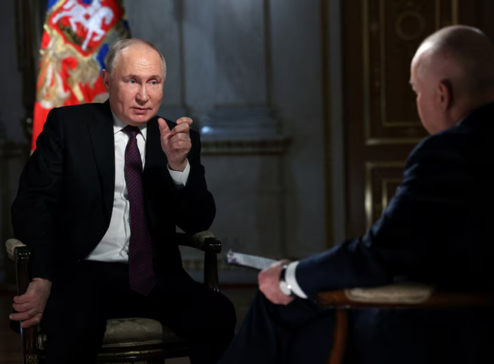 Putin speaks during an interview/Reuters
