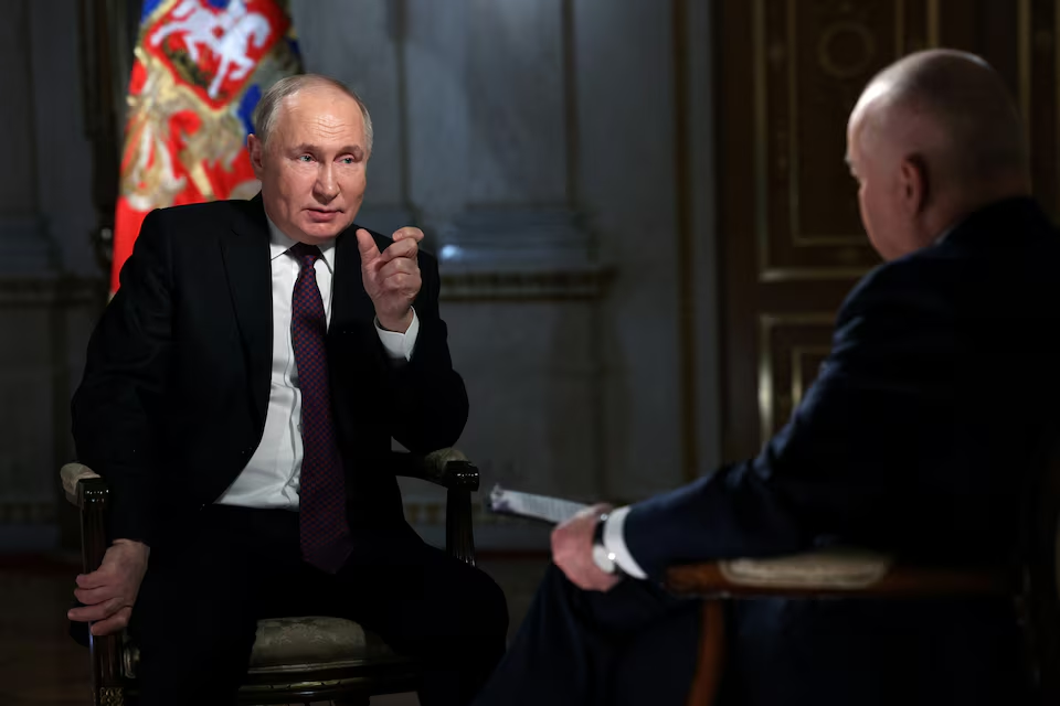 Putin speaks during an interview/Reuters