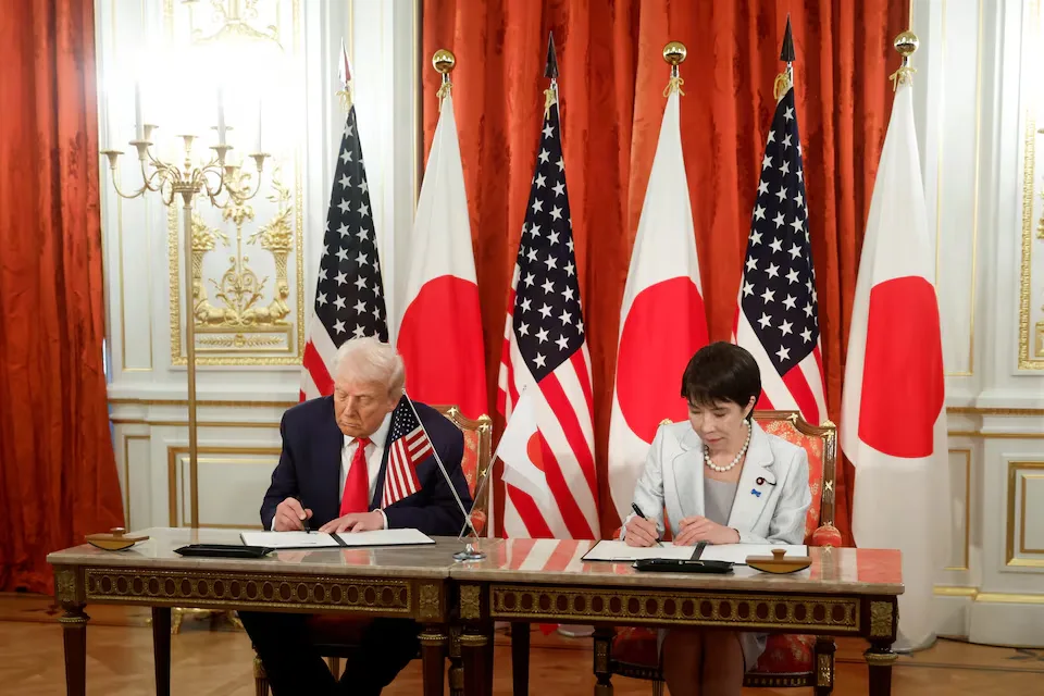 Japanese Prime Minister Sanae Takaichi and US President Donald Trump participate in a signing ceremony at Tokyo's Akasaka Palace state guest house on Tuesday, October 28, 2025, formalizing implementation details of the bilateral trade agreement between the United States and Japan. Kiyoshi Ota/Pool via REUTERS