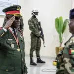 On Thursday, November 27, 2025, General Horta Inta-A of Guinea-Bissau salutes an officer at his swearing-in ceremony in Bissau, where he assumed the role of transitional leader and head of the High Command [Patrick Meinhardt/AFP]