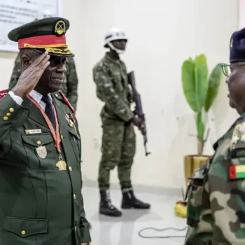 On Thursday, November 27, 2025, General Horta Inta-A of Guinea-Bissau salutes an officer at his swearing-in ceremony in Bissau, where he assumed the role of transitional leader and head of the High Command [Patrick Meinhardt/AFP]