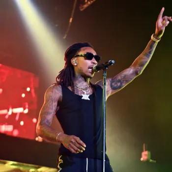 Wiz Khalifa performing on stage/Getty Images