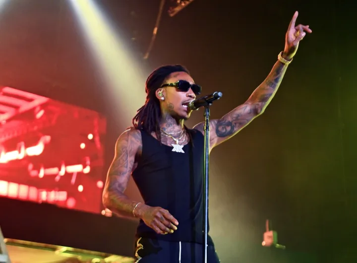 Wiz Khalifa performing on stage/Getty Images