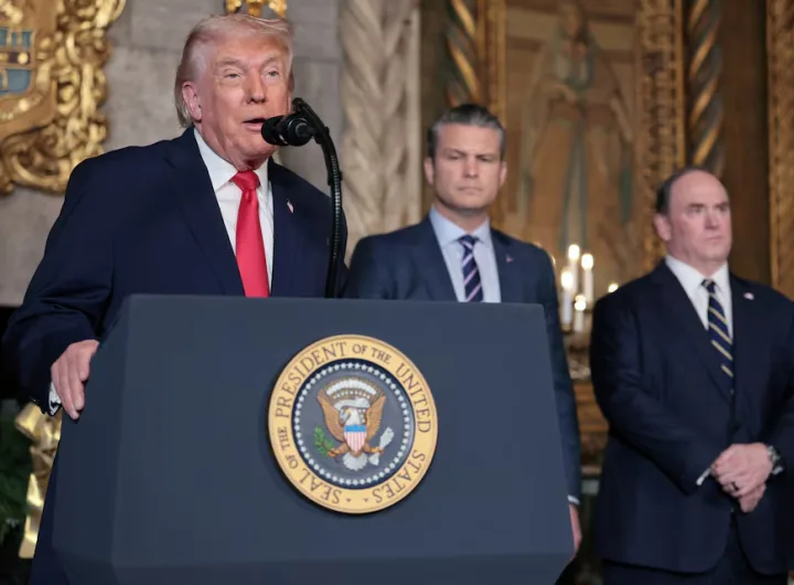 President Donald Trump discusses the Navy's "Golden Fleet" initiative at his Mar-a-Lago estate in Palm Beach, Florida, on December 22, 2025, while Defense Secretary Pete Hegseth and Navy Secretary John Phelan look on. REUTERS/Jessica Koscielniak