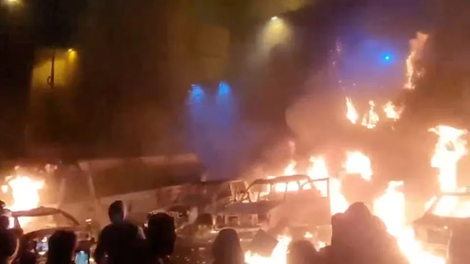 Anti-government demonstrators assemble as cars are set ablaze during ongoing civil unrest in Tehran, Iran, captured in this image taken from a social media video dated January 9, 2026. Social Media/via REUTERS