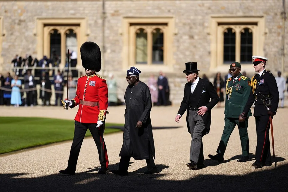 Major Benedict Tracey, Guard Commander, escorts King Charles III and President Bola Ahmed Tinubu during a ceremonial inspection of the Grenadier Guards' Guard of Honour, marking the opening day of President Tinubu's state visit to the United Kingdom at Windsor Castle, Berkshire. Photographed on Wednesday, March 18, 2026. Aaron Chown/Pool via REUTER