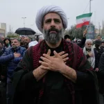 Iranians line up the stress in demonstration as the fighting continues/AP