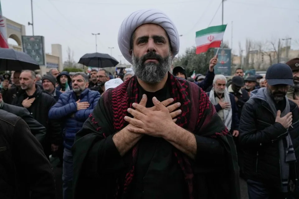 Iranians line up the stress in demonstration as the fighting continues/AP
