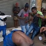 Xenophobic mob attacks a Nigerian in South Africa/Photo: Reuters