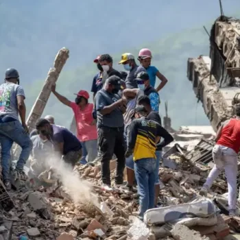 People search through the rubble/Getty Images