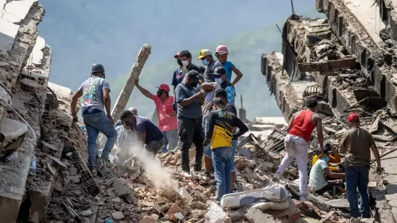 People search through the rubble/Getty Images