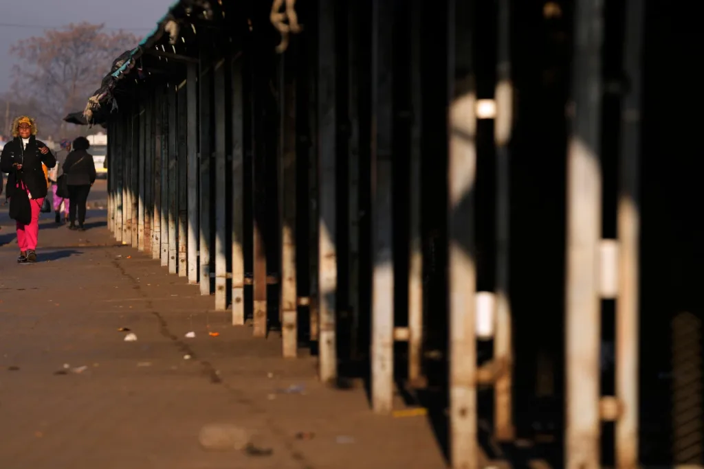 A woman walks past an empty street and market stalls in the Thokoza township, east of Johannesburg, South Africa, June 30, 2026/Photo: AP-Themba Hadebe
