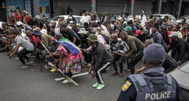 Demonstrators chant and raise their fists as members of the "March and March" movement take to the streets of Durban on June 30, 2026, protesting on a self-imposed deadline that grassroots citizen groups had set for undocumented foreign nationals to exit South Africa/AP