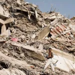 Man searches through the rubble from the earthquake in Venezuela