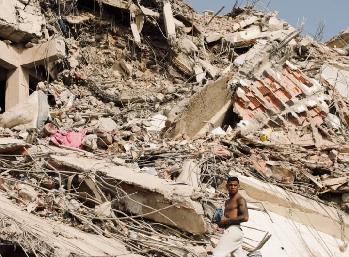 Man searches through the rubble from the earthquake in Venezuela