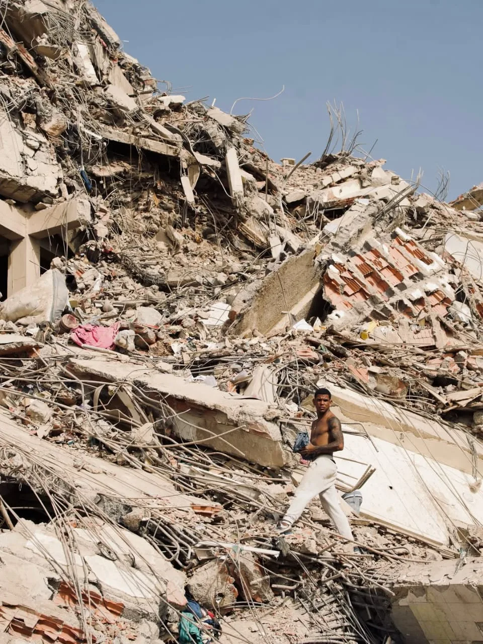 Man searches through the rubble from the earthquake in Venezuela