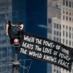 The couple delivered a peace message atop the Empire State Building/Instagram @angela_nikolau