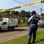 A police officer stands at the scene of a mass shooting at a house party in KwaMakhutha, a township south of Durban, South Africa, on Wednesday, Sept. 23, 2026. /Photo: AP