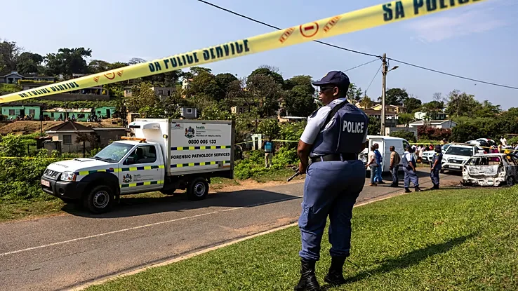 A police officer stands at the scene of a mass shooting at a house party in KwaMakhutha, a township south of Durban, South Africa, on Wednesday, Sept. 23, 2026. /Photo: AP
