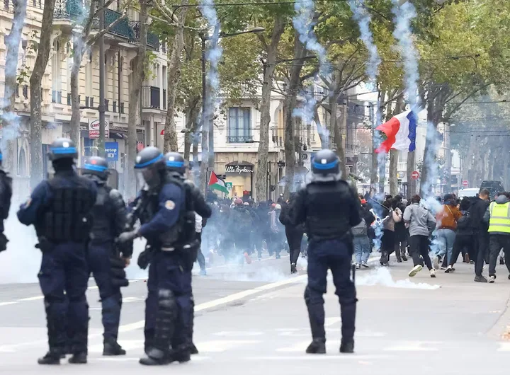 Protesters scatter as tear gas is fired during a demonstration in Lyon, France, on October 24, 2026. The rally, organized by the “Yellow Vests” movement and joined by French high school and university students, was held in defiance of a ban by local authorities and aimed at the rising cost of living and fuel prices. REUTERS/Lisi Niesner
